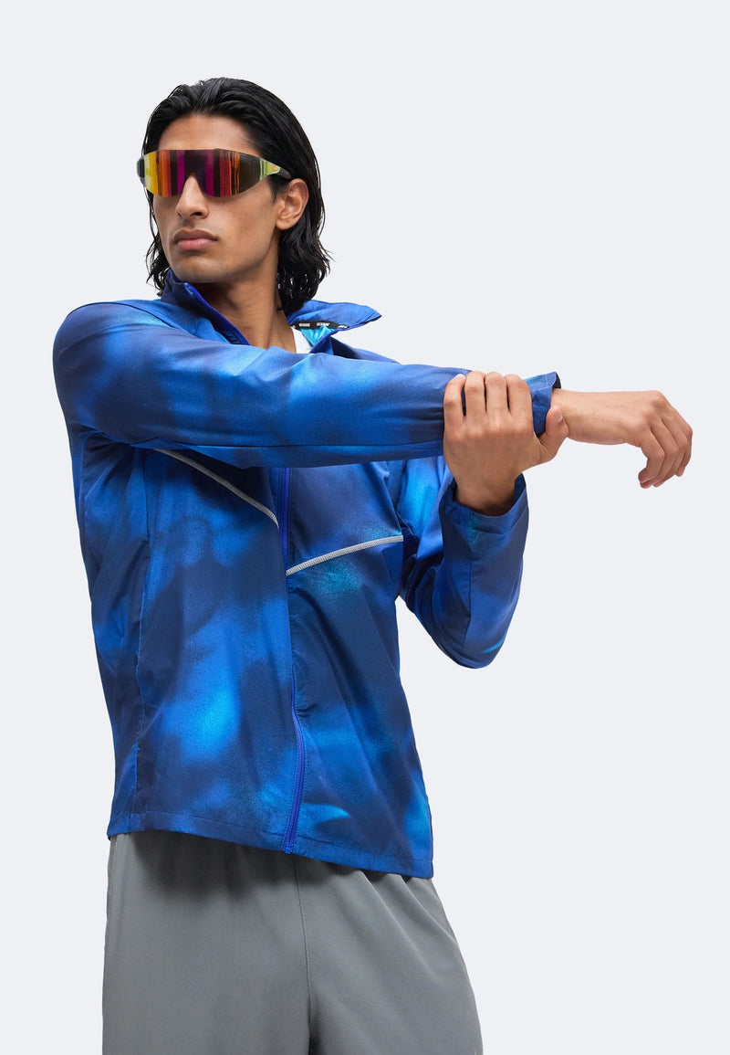 Veste Nike Windrunner bleue imprimée en mouvement, col zippé et manches ajustées