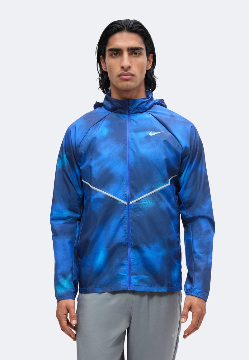 Veste Nike Windrunner bleue imprimée portée de face, capuche et chevron réfléchissant sur la poitrine